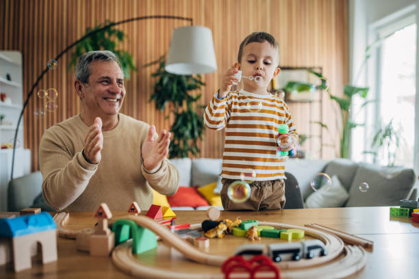 istock Little boy and grandpa playing 1589763142