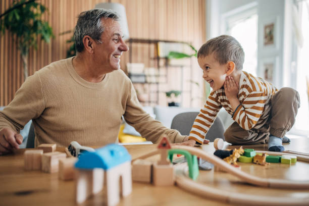 istock Little boy and grandfather playing 1589763860