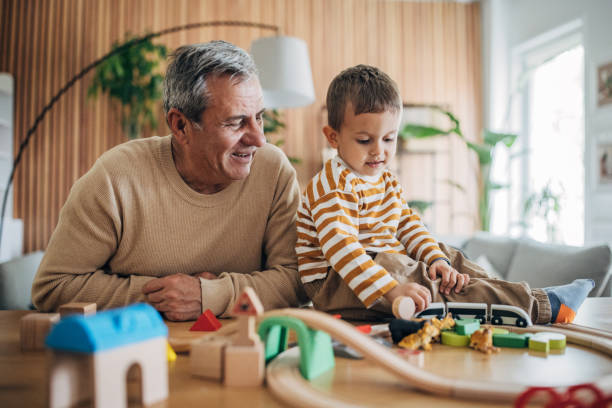 istock Little boy and grandfather playing 1589763981