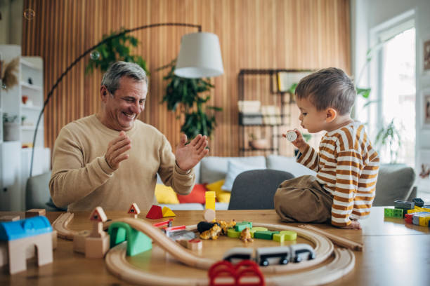 istock Little boy and grandfather playing 1589764068