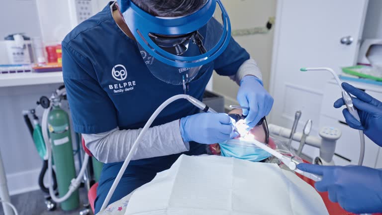 Male dentist performs procedure on a pediatric patient