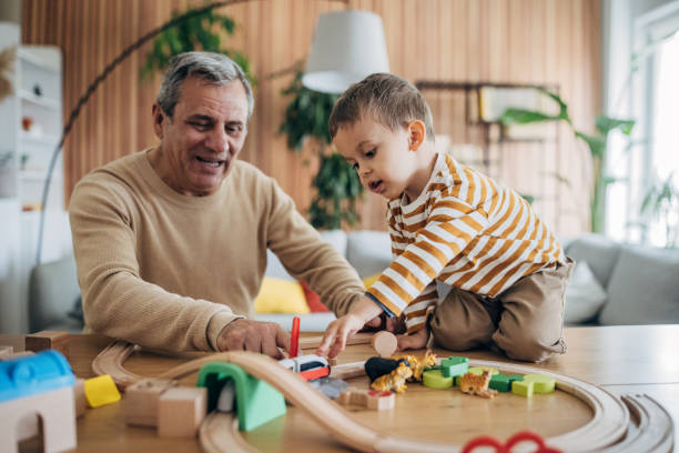 istock Boy and grandfather playing at home 1589764825