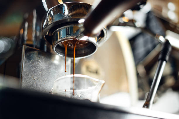 istock Close-up of coffee pouring in cup 1589768211