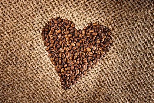 Coffee beans heart on white background.