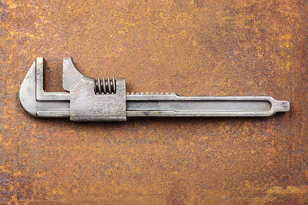 istock Vintage steel wrench on a rusty background 158982644