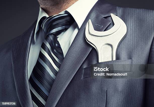 Man Wearing Suit Jacket And Tie With Spanner In Pocket Stock Photo - Download Image Now