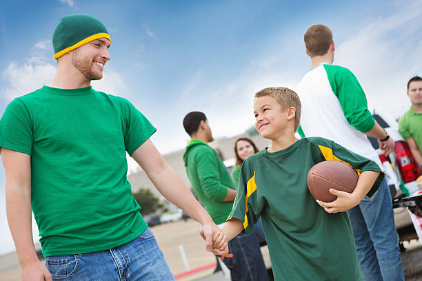 Dad tailgating with son at college football stadium Dad tailgating with son at college football stadium.  people family tailgate party outdoors stock pictures, royalty-free photos & images