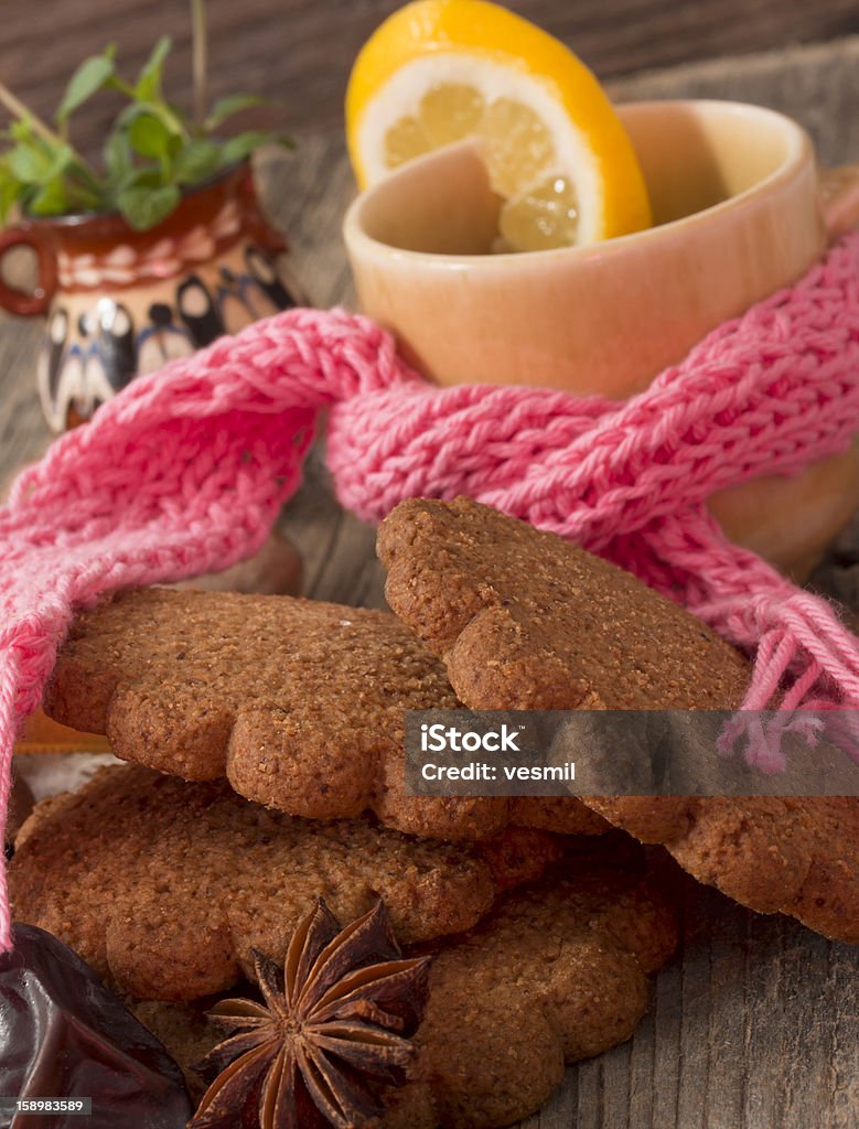 winter arrangement with tea and biscuits on the wooden table Anise Stock Photo