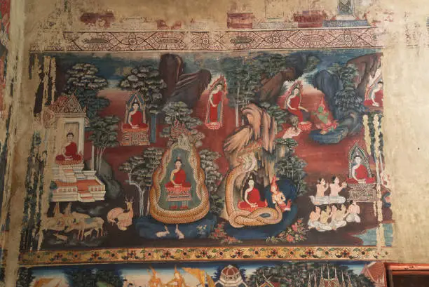 Wall mural painting inside the church at Wat Kongkharam Mon people's artwork, The color of the picture is natural color.Extracted from the bark and flowers in those days Wrote about the history of the Buddha, about 250 years old. Located at Ratchaburi Province in Middle of Thailand.