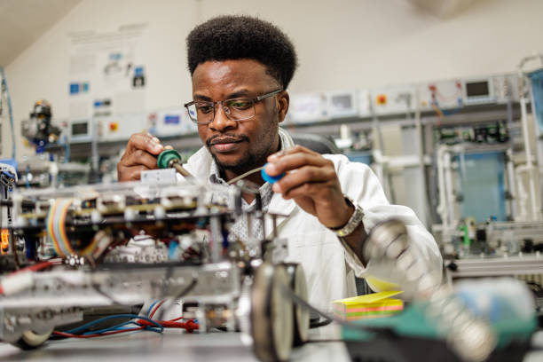 istock Mechanical engineer solders in laboratory 1589845622