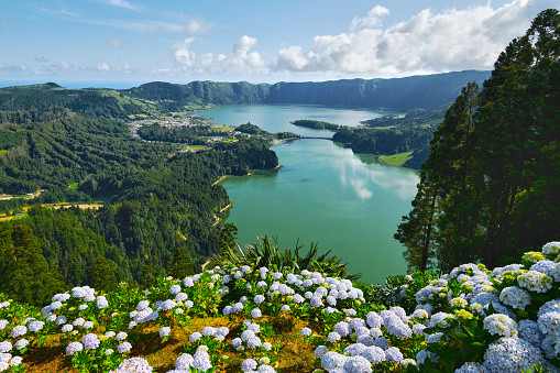 Picturesque view of Sete Cidades in Azores, Sao Miguel. Volcanic craters and stunning lakes at sunny day. Ponta Delgada, Portugal. Natural wonders, landmarks and tourist attractions concept