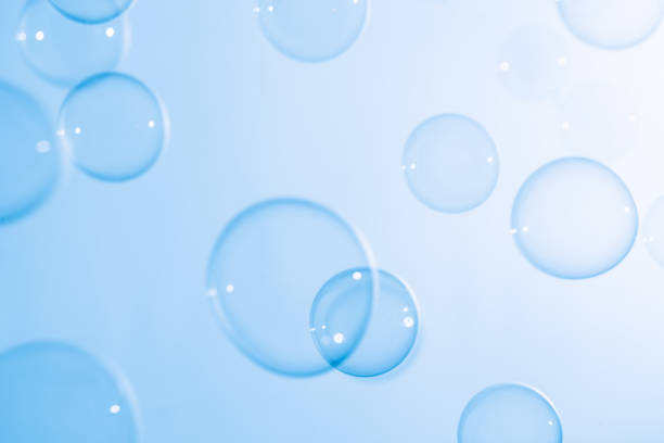 istock Beautiful Transparent Blue Soap Bubbles Floating in The Air. White Space, Abstract Fun Background, Blue Gradient Blurred Background, Refreshing of Soap Suds Bubbles Water. 1589855830