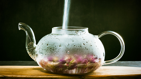 Hot water is poured into the kettle, clover tea is brewed, long exposure