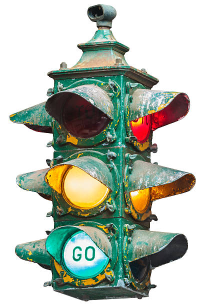 Vintage illuminated American traffic light isolated on white