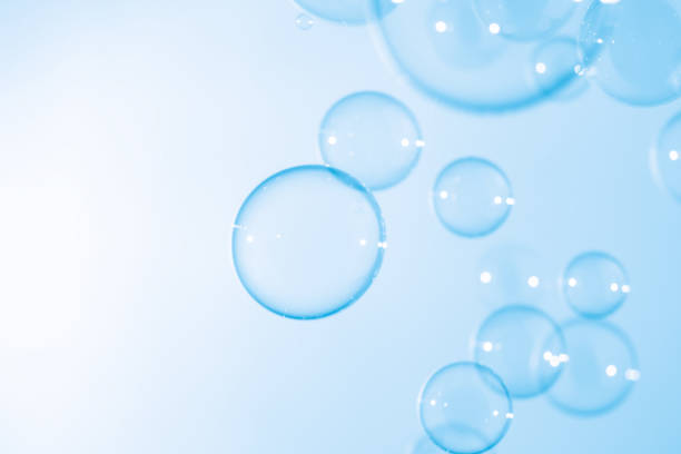 istock Beautiful Transparent Blue Soap Bubbles Floating in The Air. White Space, Abstract Fun Background, Blue Gradient Blurred Background, Refreshing of Soap Suds Bubbles Water. 1589861339