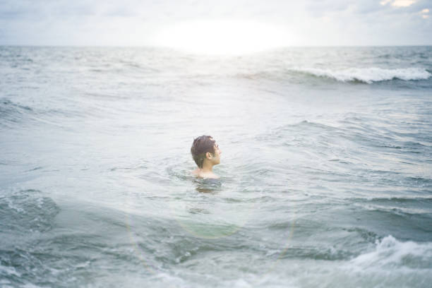 istock Young people surfing on beach surfboards 1589863008