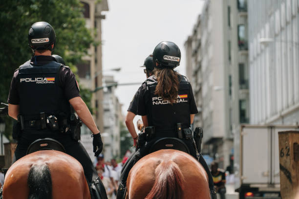 Detail of police officers on horses Pamplona, Spain - 7 July 2023: Detail of Spanish policemen and women on horses police policewoman women spain stock pictures, royalty-free photos & images
