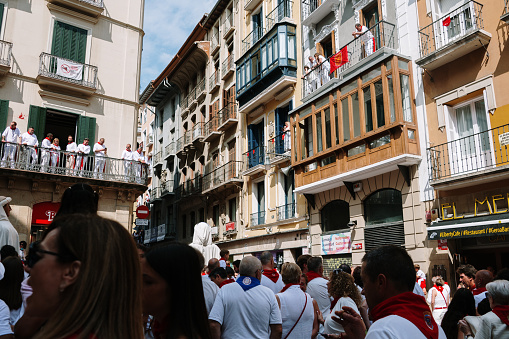 Pamplona, Spain - 7 July 2023: A crowded street in Pamplona, Spain during the annual San Fermin celebration