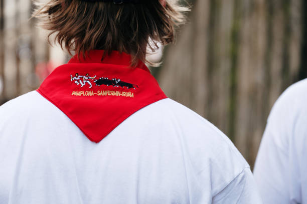 Pamplona, Spain - 7 July 2023: Detail of a person with a red neckerchief during San Fermin in Pamplona, Spain
