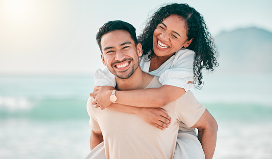 Love, happy and piggyback with couple on beach for travel, summer and vacation. Peace, smile and relax with portrait of man and woman hugging on date for seaside holiday, care and mockup space