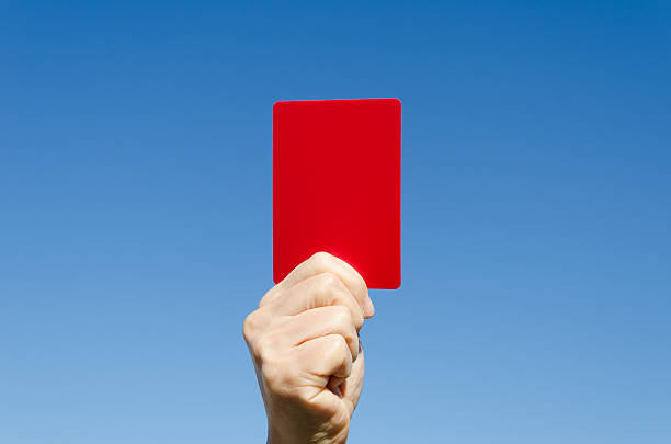 istock Red card in the hand against blue sky 158987798