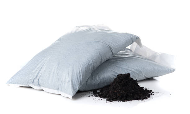 istock Organic soil with bag for planting on white background 1589885421