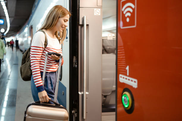 istock Woman Getting on Train at Train Station 1589885431