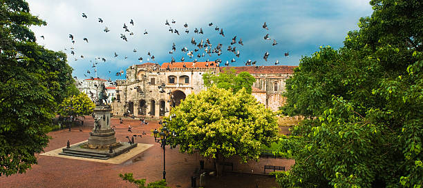 Santo Domingo Main Square Doves flying over main square with Columbus statue, Santo Domingo, Dominican Republic dominican republic stock pictures, royalty-free photos & images