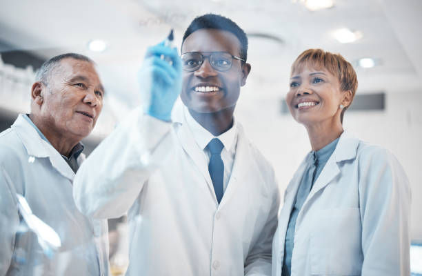 istock Science, writing formula and team in laboratory for experiment, chemistry equation and medical research. Healthcare, biotechnology and happy scientists writing on glass, brainstorming and thinking 1589911861
