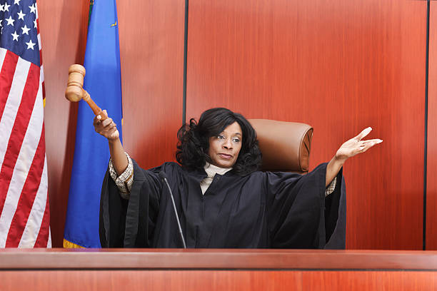 Female Judge Seated in Courtroom stock photo