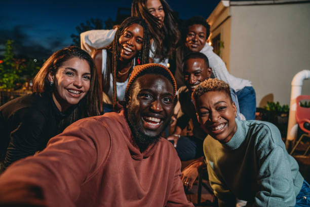 istock Multiethnic group of people are taking a selfie together during a dinner party 1589926410