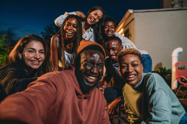 istock Multiethnic group of people are taking a selfie together during a dinner party 1589926415