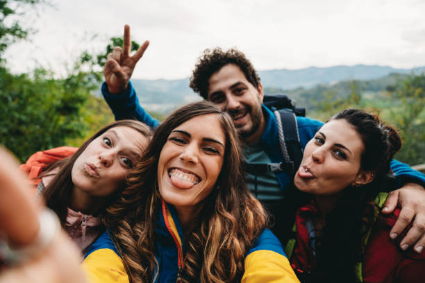 istock Four friends are taking a selfie during a trekking together 1589926933