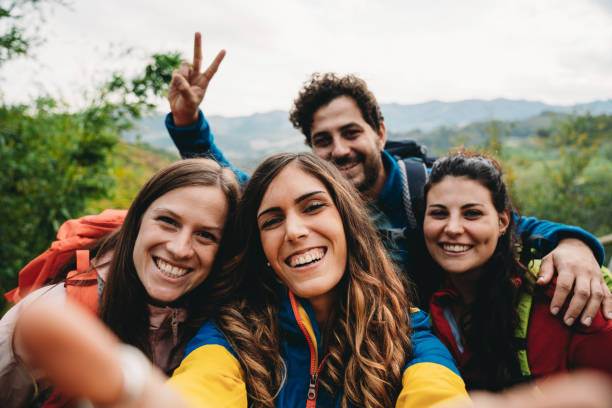 istock Four friends are taking a selfie during a trekking together 1589926934