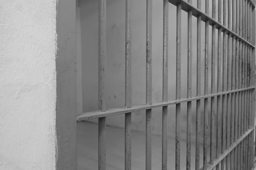 View of prison cells in dramatic black and white tones.