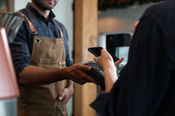istock Woman use smartphone to scan QR code to pay in cafe restaurant with a digital payment without cash. Choose menu and order accumulate discount. E wallet, technology, pay online, credit card, bank app 1589930214