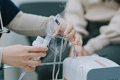 Female Doctor giving medical oxygen to her patient in medical examination room