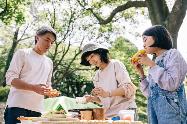istock Japanese family cooking outdoors while camping 1589947043