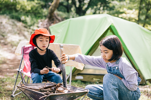 Young members of a Japanese play games and explore their surroundings. Camping becomes an avenue for fun, education, and unforgettable family moments.