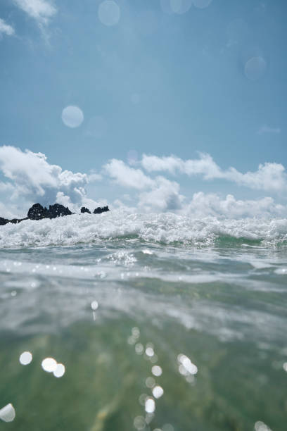 istock Blue skies, sea surface, wave approaches the camera at Pedn Vounder Beach, Cornwall on a sunny June day. 1589950241