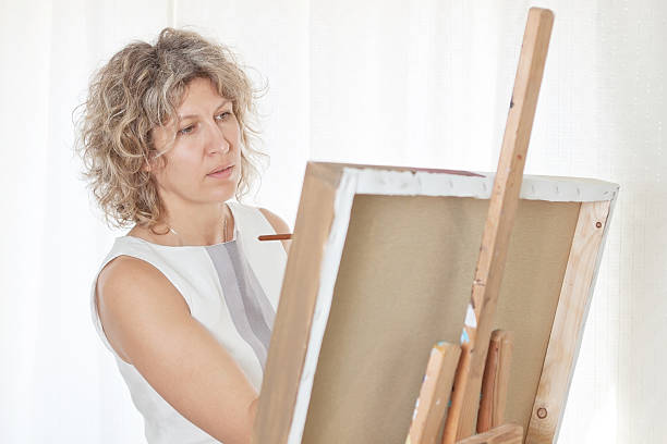 istock Beautiful artist paints a picture. 158996049