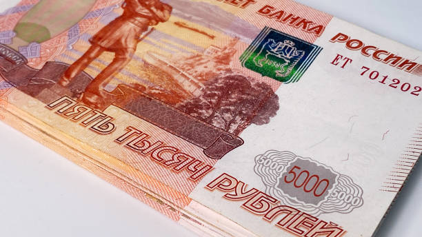 istock A stack of five thousand ruble bills lies on a white table, close-up. Banknotes of 5000 rubles. Tickets of the Bank of Russia. Economics and finance. 1589967091