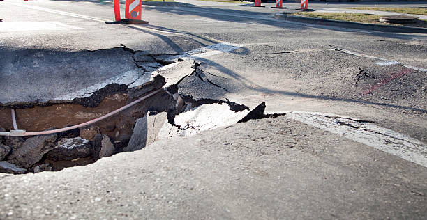 Broken Road Road Damage. sinkhole stock pictures, royalty-free photos & images