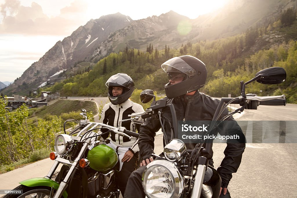 Motorcycle Couple Motorcycle couple parked and enjoying view of snow capped mountains Motorcycle Stock Photo