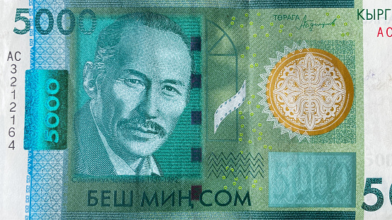 Top view of the 5000 SOM bill. Portrait of Kyrgyz Soviet actor Suymenkul Chokmorov. Five thousand som. Kyrgyz national currency. Background of money. The current money of Kyrgyzstan. Economics and finance.