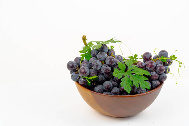 istock Purple grape Kyoho Grape with leaves on white background 1589976672