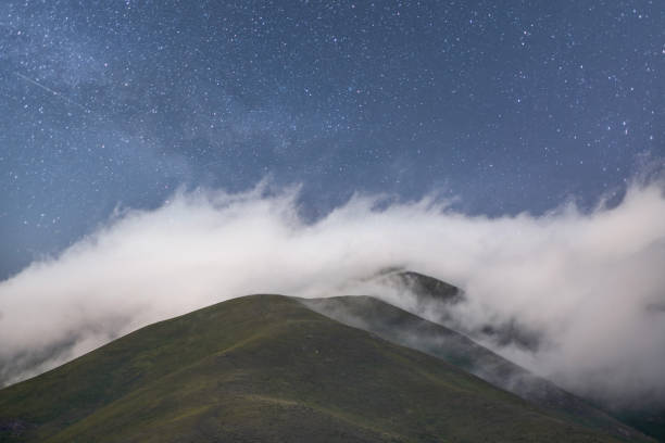 istock Beautiful landscape,  clouds in the mountains in the night . 1589978727
