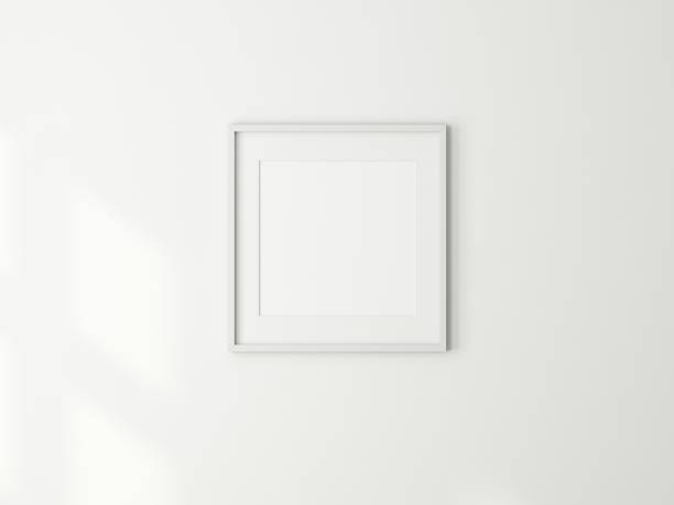 istock Square Art Frame Mockup with passepartout on white wall 1589984180