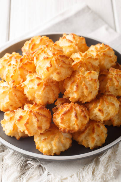 istock Coconut cookies macarons closeup on the plate. Vertical 1589990187