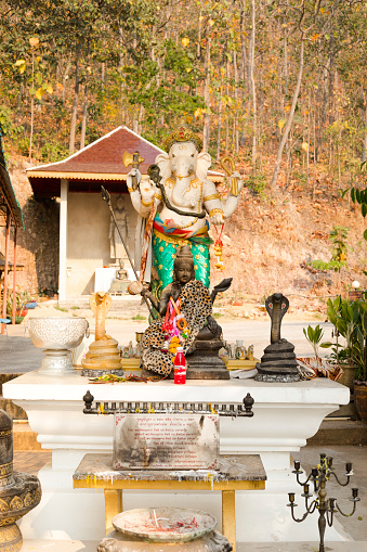 Hindu goddess Saraswati in front of Genasha statue at Wat Doi Thaen Phra Pha Luang in San Sai  district of Chiang Mai